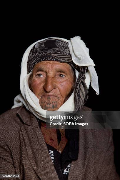 Adule Ali, about 80, from Kobane, Syria, photographed at a refugee camp in Turkey. "When I was young, a gypsy woman made my tattoos." said Adule. As...