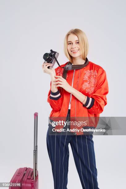 young woman with travel suitcase and a photo camera - andriy onufriyenko stockfoto's en -beelden