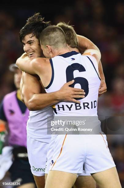 Darcy Fogarty of the Crows is congratulated by team mates after kicking a goal during the round one AFL match between the Essendon Bombers and the...