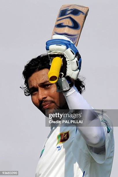 Sri Lankan batsman Tillakaratne Dilshan celebrates on scoring a century on the first day of the third cricket Test between India and Sri Lanka in...