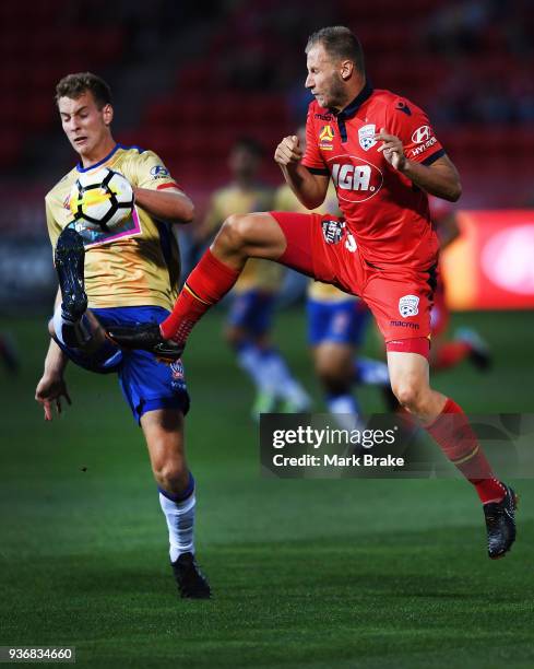 Dzengis Cavusevic of Adelaide United crashes into Lachlan Jackson of the Newcastle Jets during the round 24 A-League match between Adelaide United...