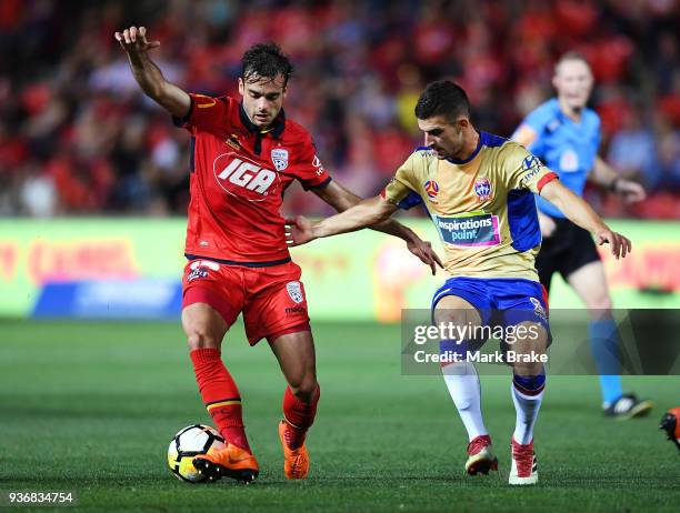 Nikola Mileusnic of Adelaide United competes with Benjamin Kantarovski of the Newcastle Jets during the round 24 A-League match between Adelaide...
