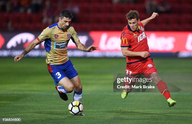 Jason Hoffman of the Newcastle Jets and Johan Absalonsen of Adelaide United during the round 24 A-League match between Adelaide United and the...