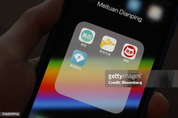 Meituan Dianping application icons Meituan, clockwise from left, Meituan Waimai, Maoyan and Meituan Wallet are displayed on an Apple Inc. IPhone in...
