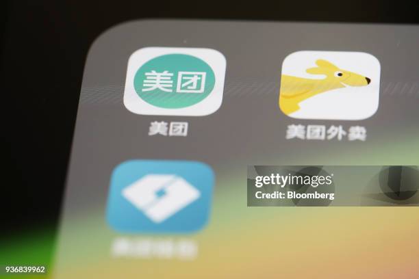 Meituan Dianping application icons Meituan, clockwise from left, Meituan Waimai and Meituan Wallet are displayed on an Apple Inc. IPhone in an...