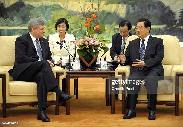 Chinese President Hu Jintao talks with Canada's Prime Minister Stephen Harper before their meeting at the Great Hall of the People on December 3,...