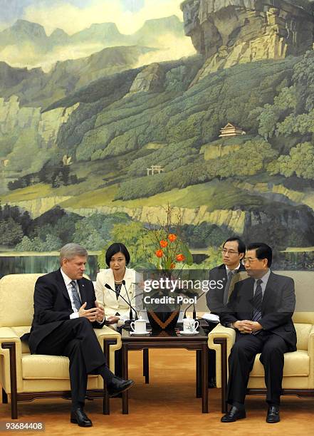 Chinese President Hu Jintao talks with Canada's Prime Minister Stephen Harper before their meeting at the Great Hall of the People on December 3,...