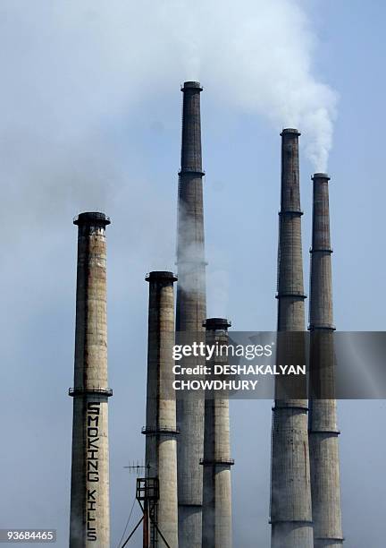 In this picture taken on October 11 smoke billows out of the chimneys where Greenpeace activists painted a message reading 'Smoking Kills' on a 250...