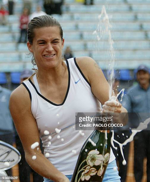 Amelie Mauresmo of France sprays champagne after winning the final match at the Italian Masters against U.S. Jennifer Capriati in Rome 16 May 2004....
