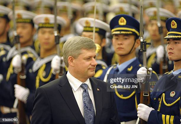 Canada's Prime Minister Stephen Harper reviews a Chinese People's Liberation Army honor guard during the welcoming ceremony at the Great Hall of the...