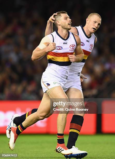 Bryce Gibbs of the Crows is congratulated by Sam Jacobs after kicking a goal during the round one AFL match between the Essendon Bombers and the...