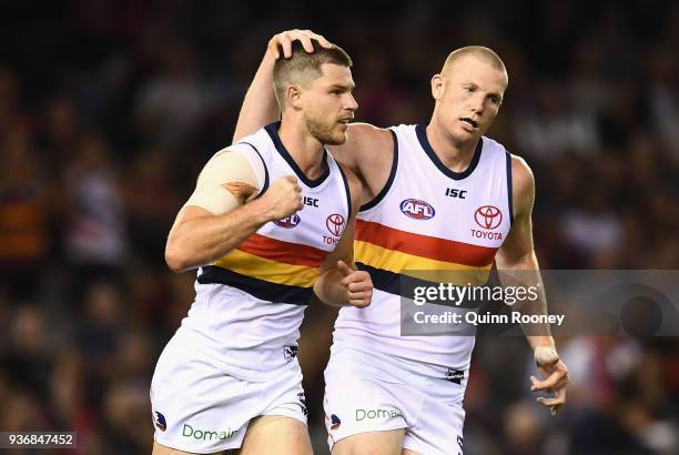 Bryce Gibbs of the Crows is congratulated by Sam Jacobs after kicking a goal during the round one AFL match between the Essendon Bombers and the...