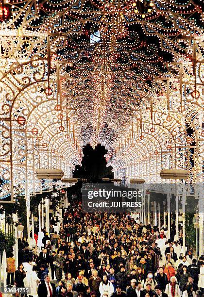 Thousands of people enjoy the colorful illuminations presentation called "Kobe Luminarie" at a shopping street in Kobe in Hyogo prefecture, western...