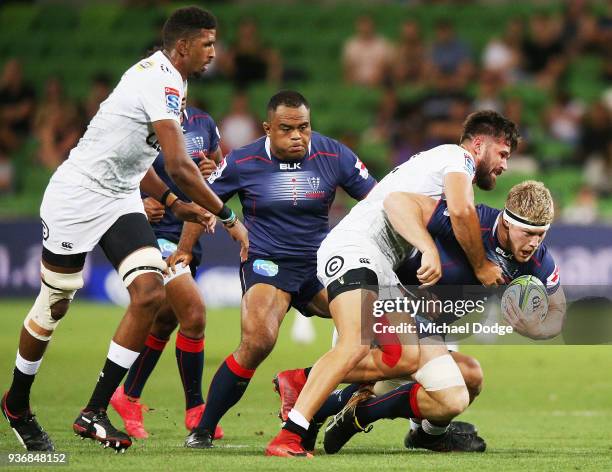 Matthew Philip of the Rebels gets tackled during the round six Super Rugby match between the Melbourne Rebels and the Sharks at AAMI Park on March...