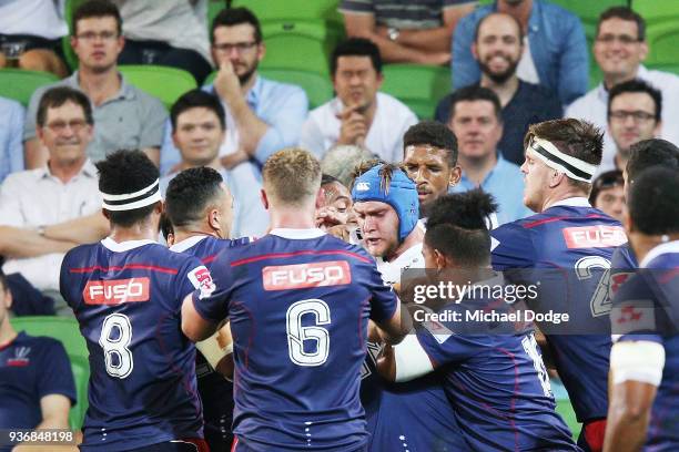 Players confront eachother after a contest during the round six Super Rugby match between the Melbourne Rebels and the Sharks at AAMI Park on March...