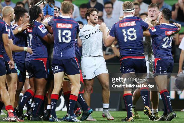 Players confront each other after a contest during the round six Super Rugby match between the Melbourne Rebels and the Sharks at AAMI Park on March...