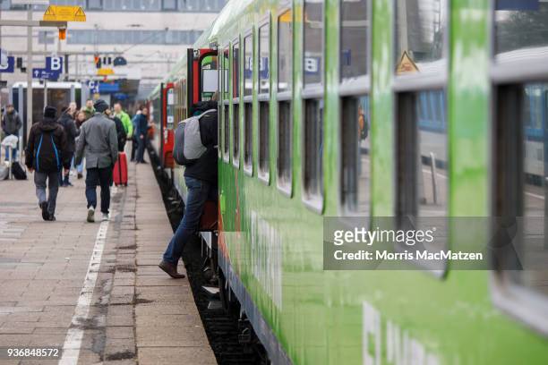 Passenger enters a Flixtrain as its ready to depart for its first Journey from Hamburg to Cologne on March 23, 2018 in Hamburg, Germany.