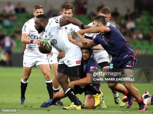 Tendai Mtawarira of the Sharks breaks a tackle during the Super Rugby union match between the Melbourne Rebels of Australia and the Coastal Sharks of...