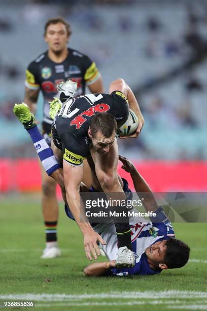 Isaah Yeo of the Panthers is tackled during the round three NRL match between the Bulldogs and the Panthers at ANZ Stadium on March 23, 2018 in...