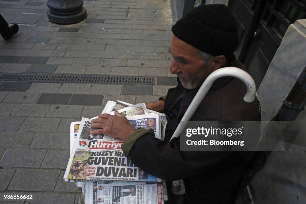 Street vendor sells copies of Hurriyet newspaper, published by Dogan Yayin Holding AS, in Istanbul, Turkey, on Thursday, March 22, 2018. Turkish...