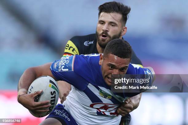 Marcelo Montoya of the Bulldogs is tackled by Josh Mansour of the Panthers during the round three NRL match between the Bulldogs and the Panthers at...