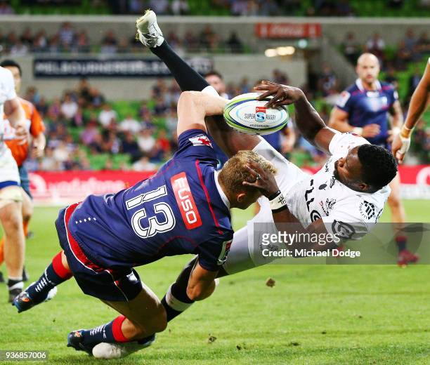 Reece Hodge of the Rebels tackles S'busiso Nkosi of the Sharks during the round six Super Rugby match between the Melbourne Rebels and the Sharks at...