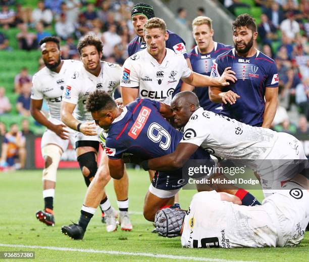 Will Genia of the Rebels scores a try during the round six Super Rugby match between the Melbourne Rebels and the Sharks at AAMI Park on March 23,...