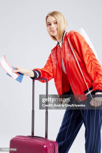 young woman with travel bag holding passport and boarding pass. - andriy onufriyenko stockfoto's en -beelden