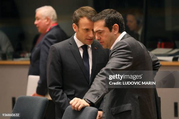 French president Emmanuel Macron speaks with Greek prime minister Alexis Tsipras during a meeting on the second day of a summit of European Union...