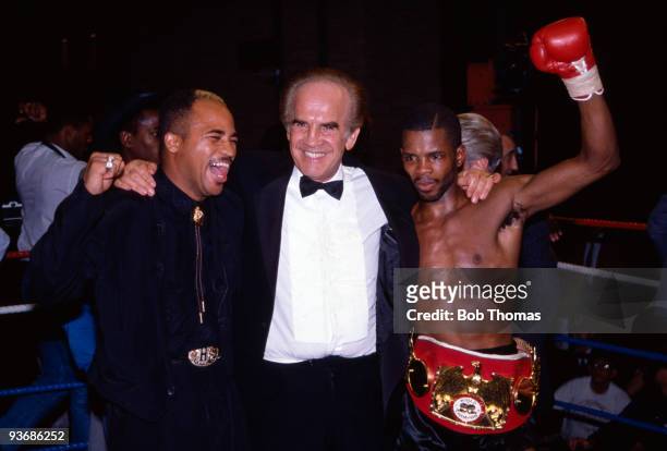 British boxer Duke McKenzie celebrates with his manager, Mickey Duff, and Lloyd Honeyghan after beating Rolando Bohol to win the IBF world flyweight...