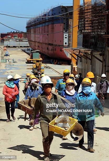 Vietnam-energy-oil-resources-development, by Peter Stebbings Locally hired female workers leave a ship building factory at Dung Quat industrial zone...