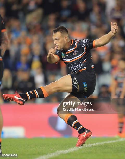 Luke Brooks of the Tigers kicks a field goal during the round three NRL match between the Wests Tigers and the Brisbane Broncos at Campbelltown...