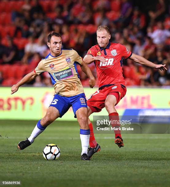 Benjamin Kantarovski of the Newcastle Jets and Dzengis Cavusevic of Adelaide United during the round 24 A-League match between Adelaide United and...