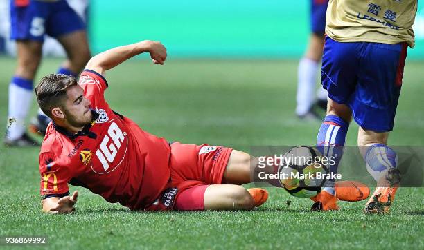 Ben Garuccio of Adelaide United tackles Riley McGree of Newcastle Jets during the round 24 A-League match between Adelaide United and the Newcastle...