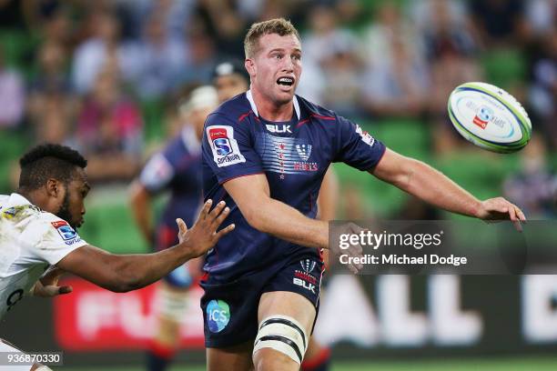 Angus Cottrell of the Rebels passes the ball during the round six Super Rugby match between the Melbourne Rebels and the Sharks at AAMI Park on March...