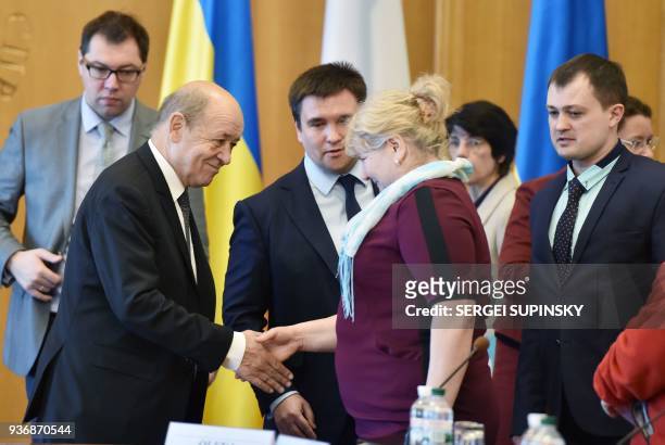 Ukrainian Foreign Affair Minister Pavlo Klimkin and his French counterpart Jean-Yves Le Drian talk with the relatives of Ukrainian political...