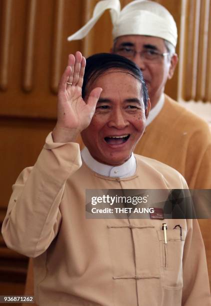 Wim Myint, member of parliament and former house speaker waves after a voting session at the lower house parliament in Naypyidaw on March 23, 2018 A...