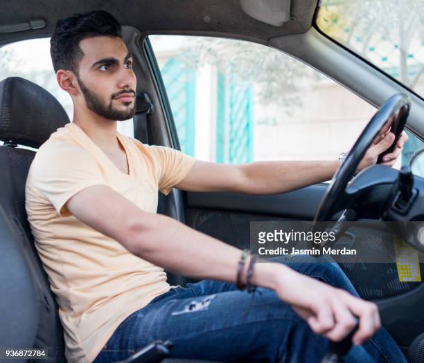 arabic guy in car - arab driving stock-fotos und bilder