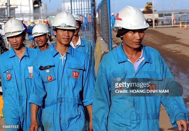 Workers leave after their working hours the Dung Quat oil refinery on February 21, 2009 in the central province of Quang Ngai. Vietnam's young and...