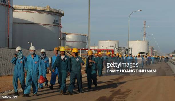 Workers leave after their working hours the Dung Quat oil refinery on February 21, 2009 in the central province of Quang Ngai. Vietnam's young and...