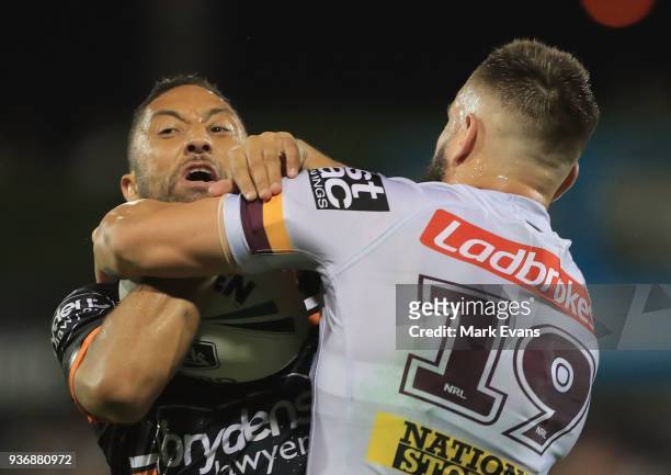Benji Marshall of the Tigers is tackled by Jack Bird of the Broncos during the round three NRL match between the Wests Tigers and the Brisbane...
