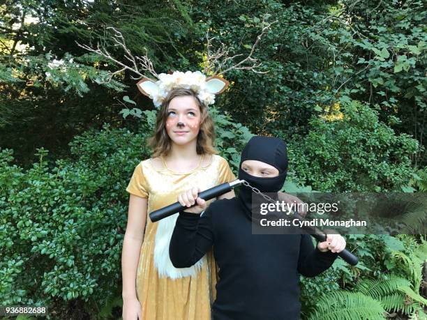 siblings dressed for halloween - ninja costume foto e immagini stock