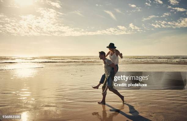 now for a little fun and a little sun - young couple on beach stock pictures, royalty-free photos & images