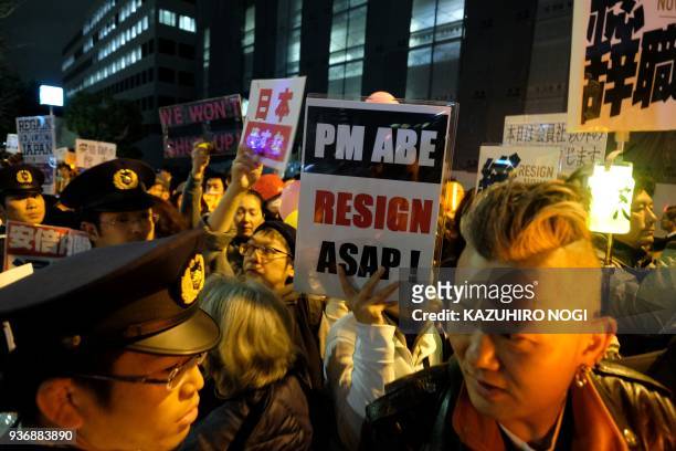 Protesters stage a demonstration near the prime minister's official residence in Tokyo on March 23, 2018 to demand the resignation of Prime Minister...