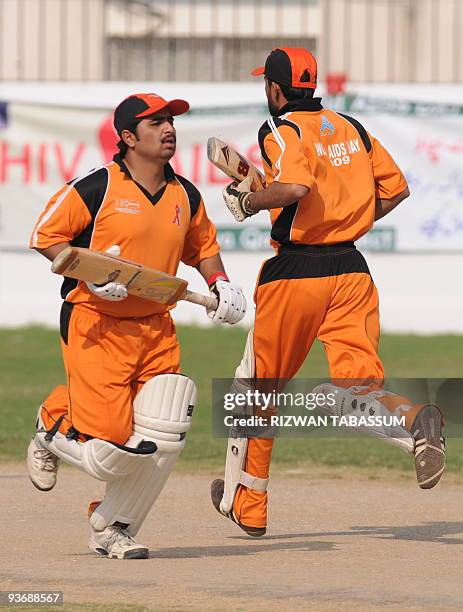 Mohammad Aqeel and Mohsin Ali, representing Pakistan's first-ever cricket team comprising people living with HIV/AIDS, run between wickets during a...