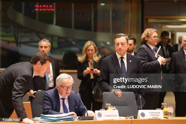 European Central Bank President Mario Draghi stands next to European Commission President Jean-Claude Juncker flanked by newly appointed Secretary...