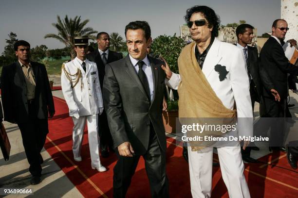 French President Nicolas Sarkozy is welcomed by Libyan Leader Muammar Gaddafi at Bab Al Azizya compound during an official visit in Tripoli, July...