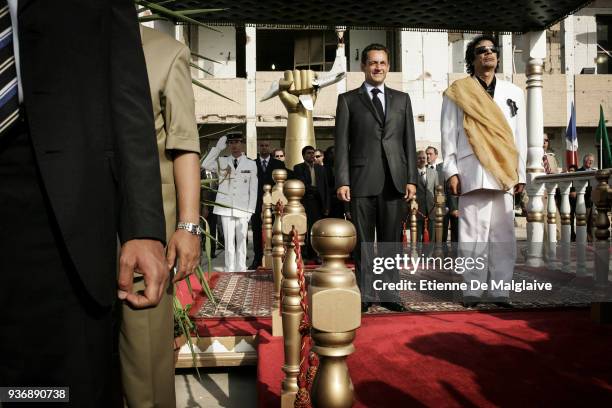 French President Nicolas Sarkozy is welcomed by Libyan Leader Muammar Gaddafi at Bab Al Azizya compound during an official visit in Tripoli, July...