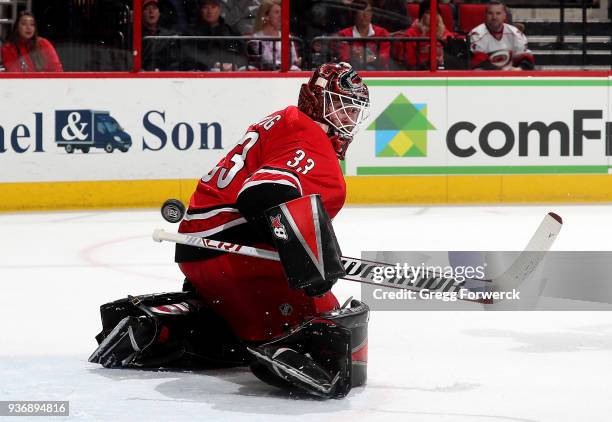 Scott Darling of the Carolina Hurricanes deflects the puck away from the crease during an NHL game against the Edmonton Oilers on March 20, 2018 at...