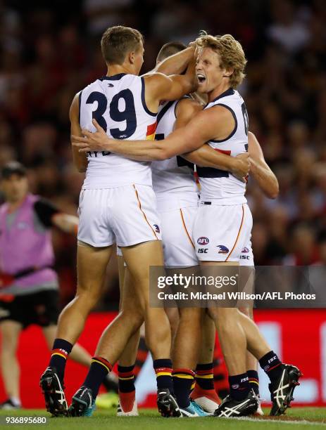 Tom Doedee and Rory Sloane of the Crows celebrates teammates Darcy Fogarty first league goal during the 2018 AFL round 01 match between the Essendon...